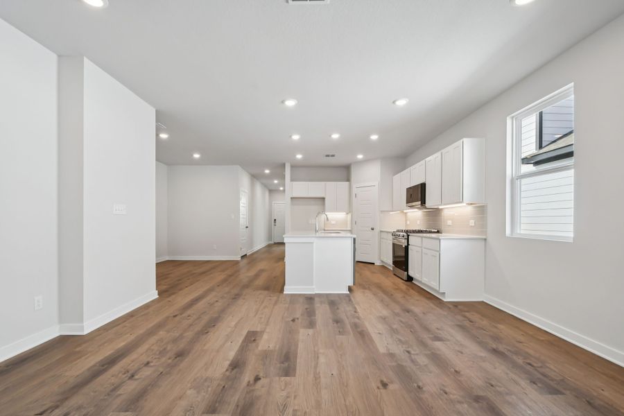 A large kitchen with white cabinets.