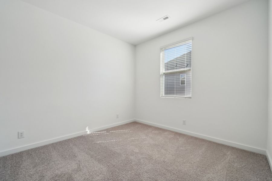 A room with a window and carpet. A room with a window and carpet.