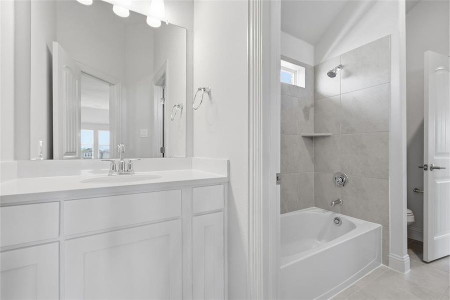 Bathroom with vanity, shower / bathtub combination, and light tile patterned floors