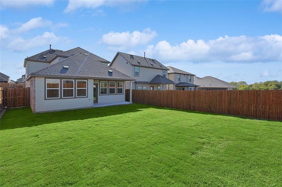 Rear view of property featuring a yard