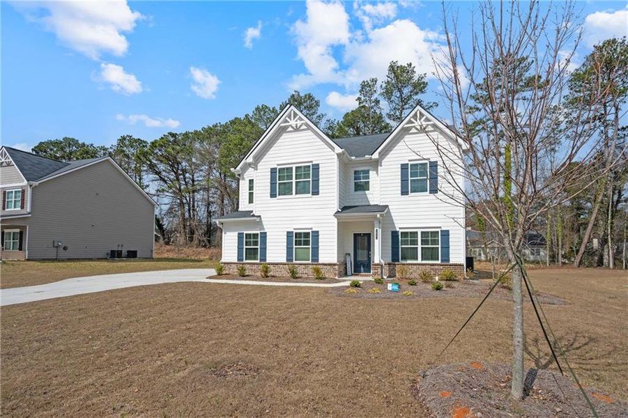 Front exterior of a new home in Stephen's Landing, Loganville, GA, highlighting curb appeal (Image 34). Front exterior of a new home in Stephen's Landing, Loganville, GA, highlighting curb appeal (Image 34).
