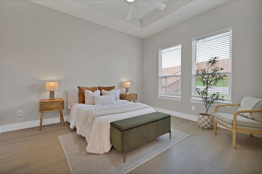 Bedroom featuring wood finished floors, baseboards, and ceiling fan