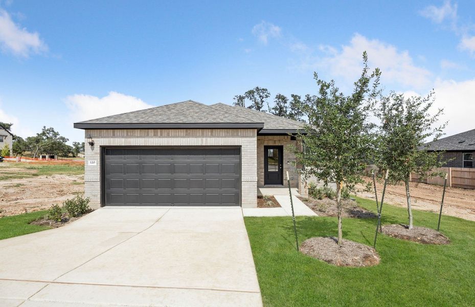 Front exterior of a new home in La Cima, San Marcos, TX, highlighting curb appeal (Image 20).