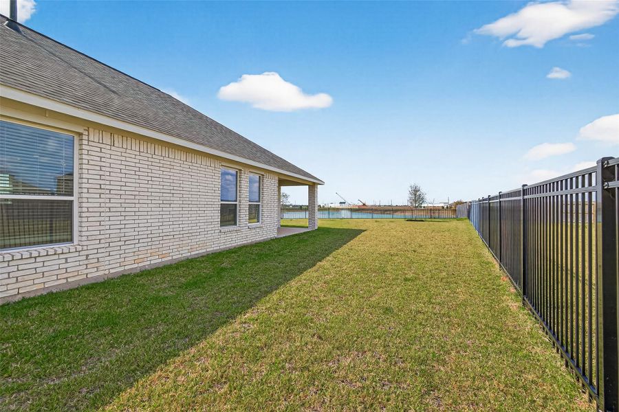 Exterior details and patio area of a home in Sunterra, Katy (Image 28).