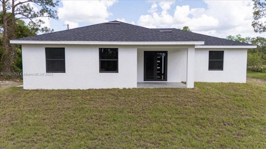 Front exterior of a new home in , Lehigh Acres, FL, highlighting curb appeal (Image 26). Front exterior of a new home in , Lehigh Acres, FL, highlighting curb appeal (Image 26).