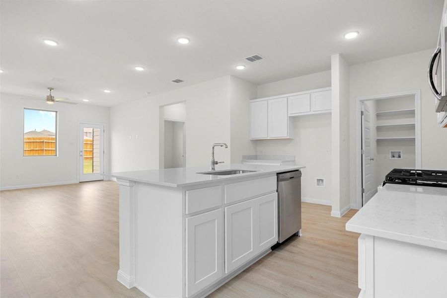 Kitchen in the Magnolia home plan by Trophy Signature Homes – REPRESENTATIVE PHOTO
