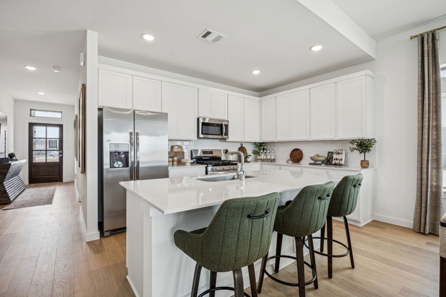 Kitchen in the Trinity home plan by Trophy Signature Homes – REPRESENTATIVE PHOTO