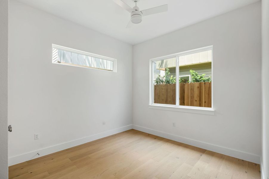 Blonde wood flooring and a pair of windows illuminate this airy, versatile room. Blonde wood flooring and a pair of windows illuminate this airy, versatile room.