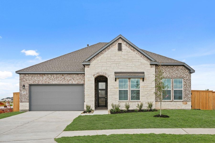 Front exterior of a new home in Sunterra Lakes, Brookshire, TX, highlighting curb appeal (Image 2). Front exterior of a new home in Sunterra Lakes, Brookshire, TX, highlighting curb appeal (Image 2).