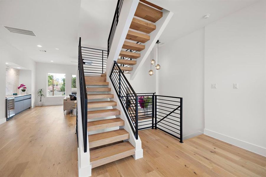 This unique modern staircase is a stunning focal point, featuring sleek, minimalist design with floating steps and a striking metal railing. Its open-concept style enhances the flow of natural light, creating a sense of space and elegance. A true architectural highlight that adds sophistication and character to the home