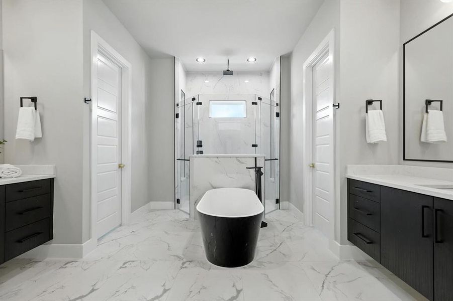 Bathroom with vanity, a freestanding tub, a marble finish shower, recessed lighting, and light marble finish floors