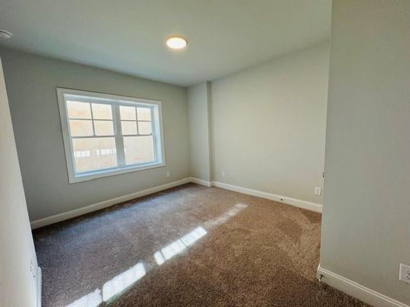 Another image of the secondary bedroom located on the first floor of the home.