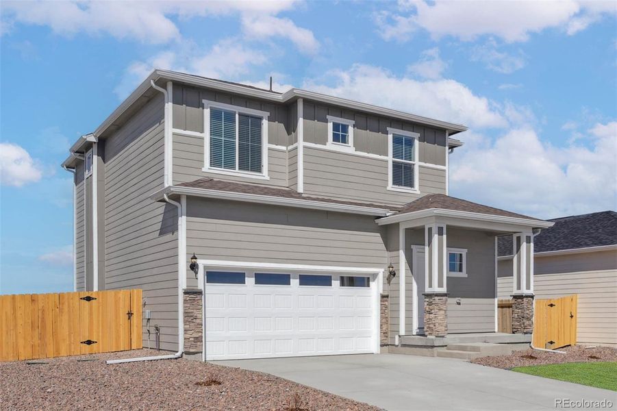 Front exterior of a new home in Second Creek Farm, Commerce City, CO, highlighting curb appeal (Image 1).