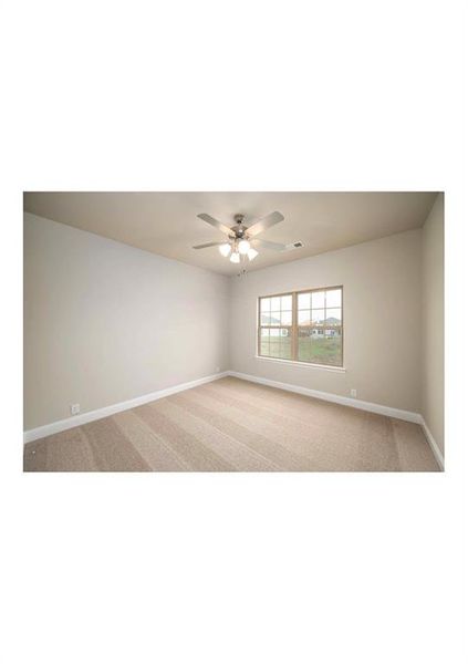 Carpeted empty room with ceiling fan