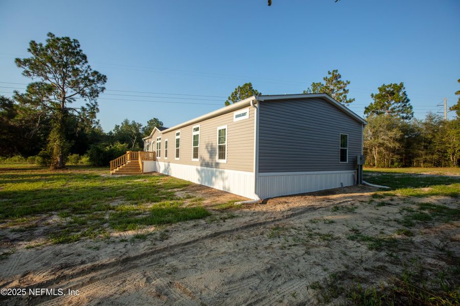 Front exterior of a new home in , Keystone Heights, FL, highlighting curb appeal (Image 27). Front exterior of a new home in , Keystone Heights, FL, highlighting curb appeal (Image 27).