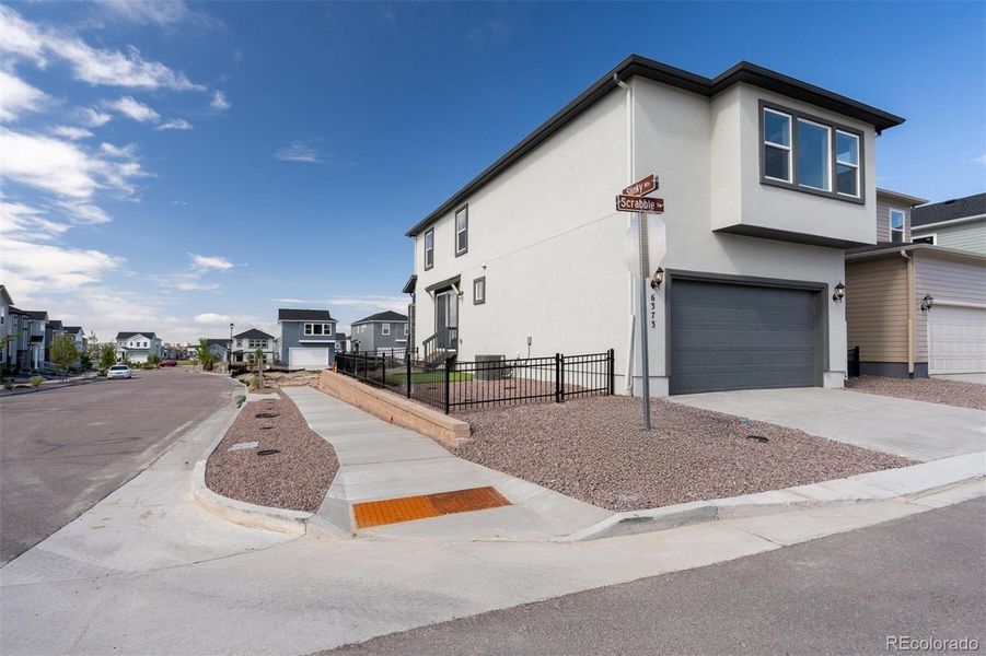 Front exterior of a new home in Revel Crossing at Wolf Ranch – The Ascent Collection, Colorado Springs, CO, highlighting curb appeal (Image 22).