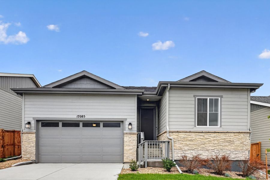 Front exterior of a new home in Trailstone, Arvada, CO, highlighting curb appeal (Image 1). Front exterior of a new home in Trailstone, Arvada, CO, highlighting curb appeal (Image 1).