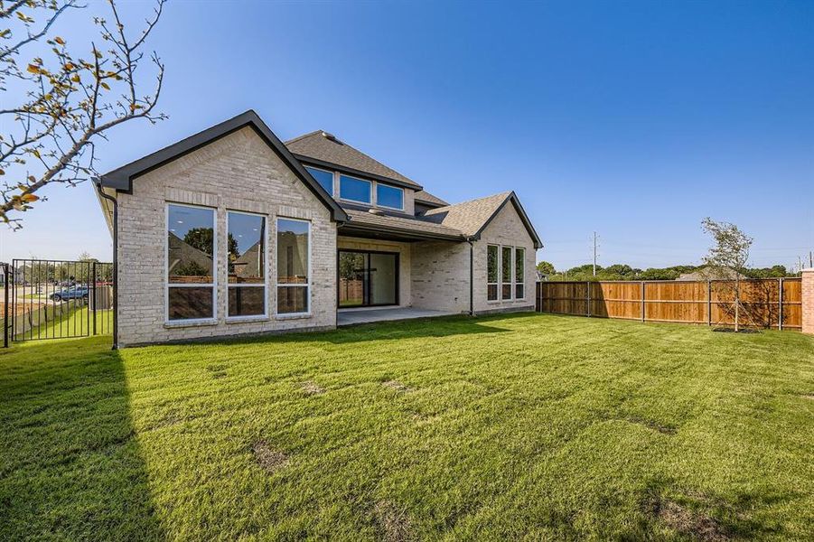 Rear view of property featuring a fenced backyard, a patio, brick siding, and roof with shingles Rear view of property featuring a fenced backyard, a patio, brick siding, and roof with shingles