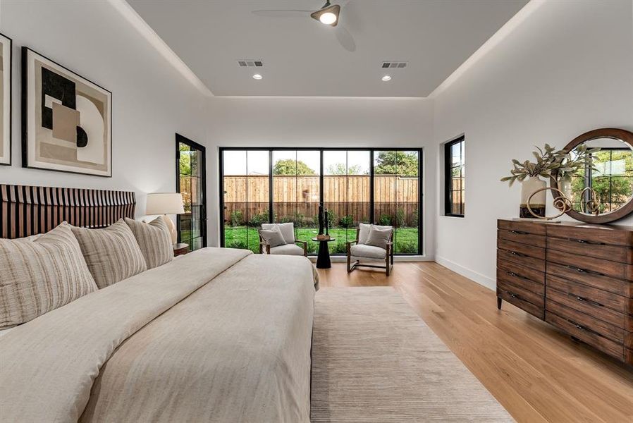 Bedroom with multiple windows, light wood-style floors, recessed lighting, and ceiling fan Bedroom with multiple windows, light wood-style floors, recessed lighting, and ceiling fan