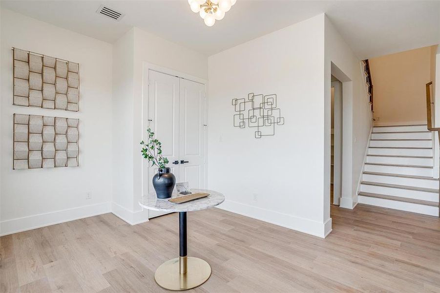 Foyer with light wood-style floors and stairway