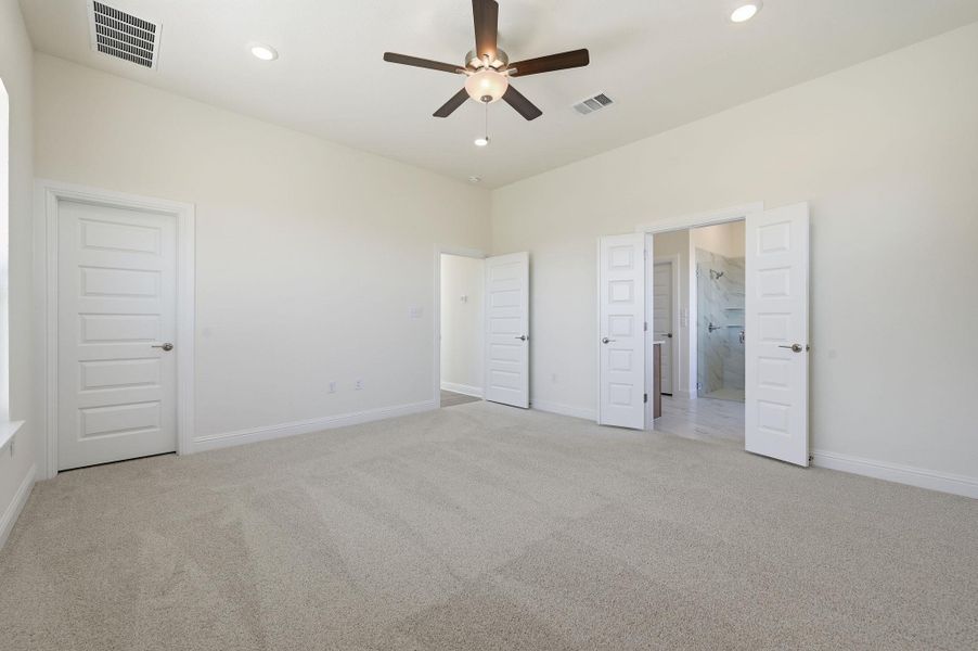 Unfurnished bedroom featuring light carpet, a ceiling fan, and recessed lighting