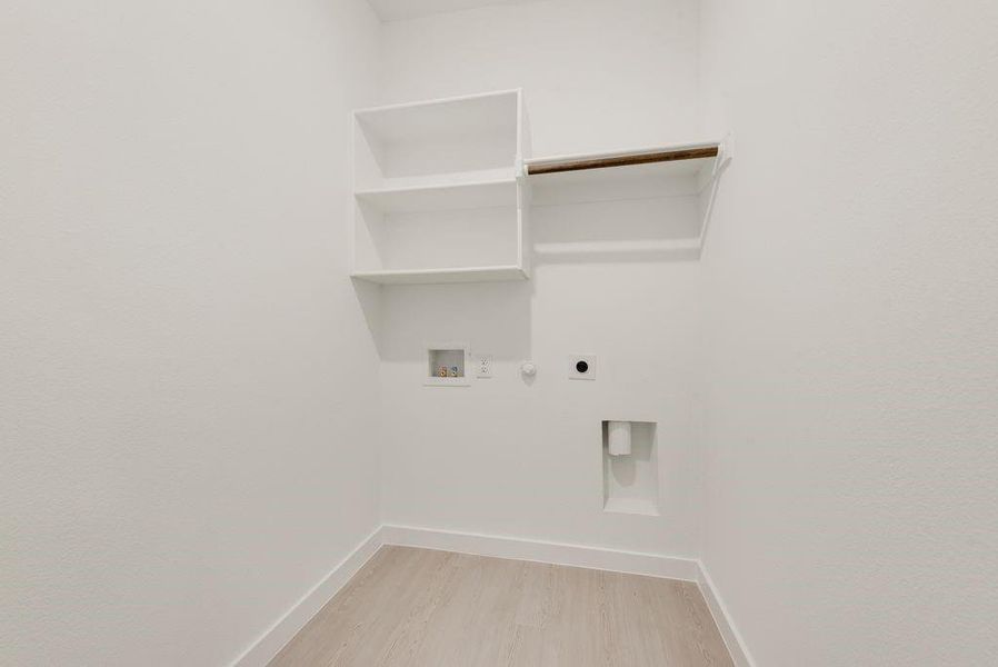Washroom featuring hookup for an electric dryer, gas dryer hookup, hookup for a washing machine, and light wood-style flooring