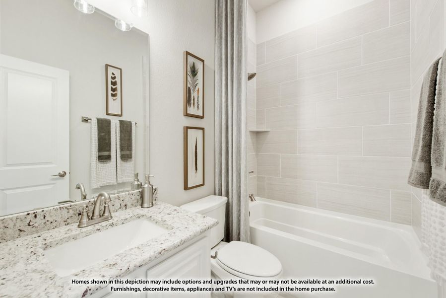 Bathroom with granite countertop vanity, white tub-shower combo with tile surround, and large mirror Bathroom with granite countertop vanity, white tub-shower combo with tile surround, and large mirror