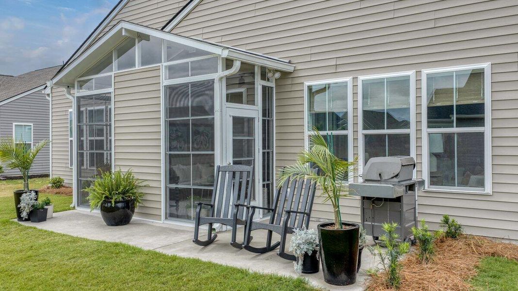 Exterior details and patio area of a home in K. Hovnanian's® Four Seasons at Lakes of Cane Bay, Summerville (Image 26).