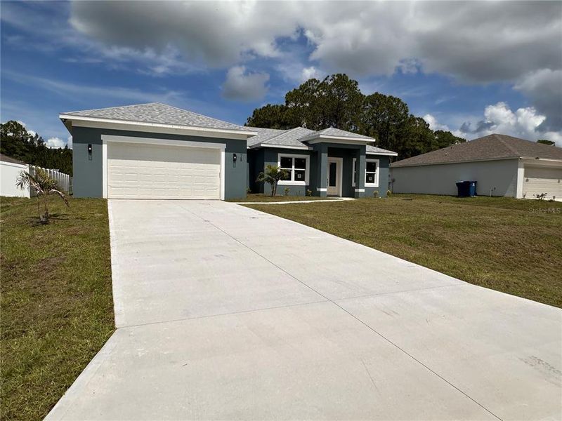 Front exterior of a new home in , Palm Bay, FL, highlighting curb appeal (Image 33). Front exterior of a new home in , Palm Bay, FL, highlighting curb appeal (Image 33).