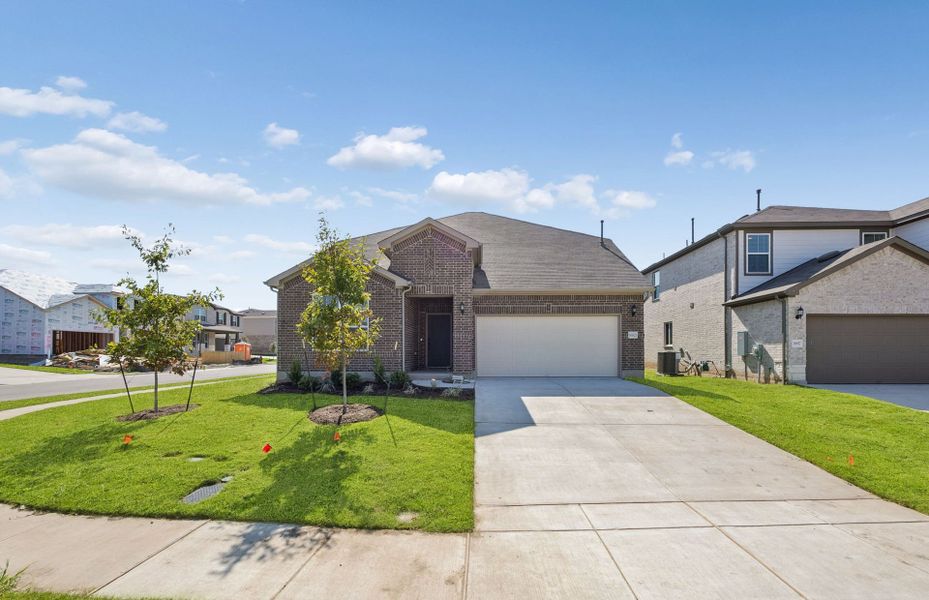 Front exterior of a new home in Lagos, Manor, TX, highlighting curb appeal (Image 21).