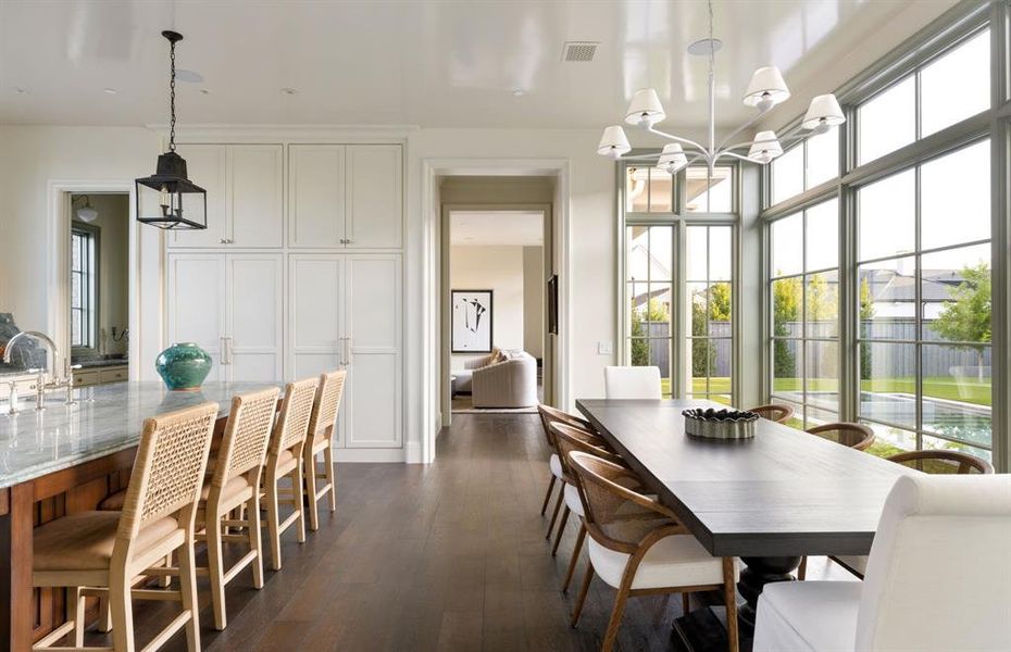 Dining room featuring a chandelier and dark wood-style flooring Dining room featuring a chandelier and dark wood-style flooring