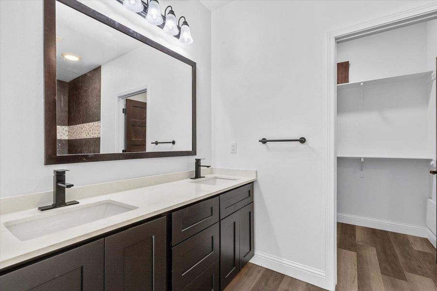 Clean lines and a double vanity define this modern bathroom with an adjoining closet. Clean lines and a double vanity define this modern bathroom with an adjoining closet.