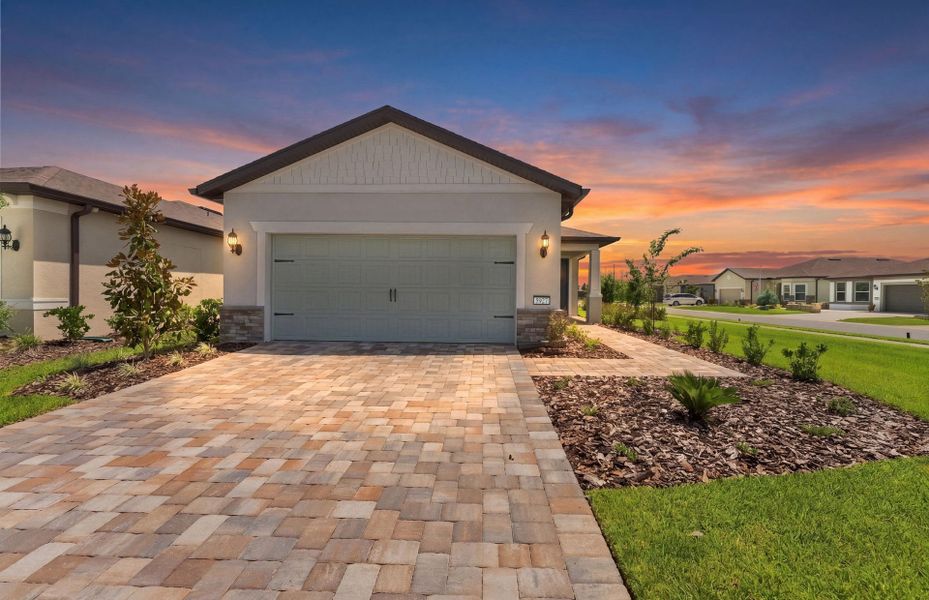 Front exterior of a new home in Del Webb Stone Creek, Ocala, FL, highlighting curb appeal (Image 2). Front exterior of a new home in Del Webb Stone Creek, Ocala, FL, highlighting curb appeal (Image 2).