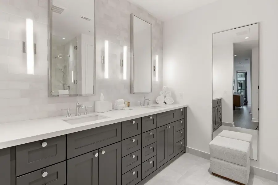 Full bath with double vanity, a shower stall, backsplash, light tile patterned flooring, and recessed lighting