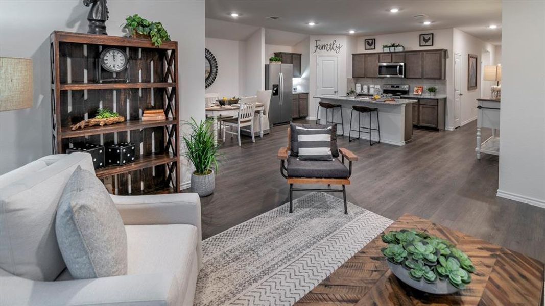 Living area with recessed lighting and dark wood-style flooring