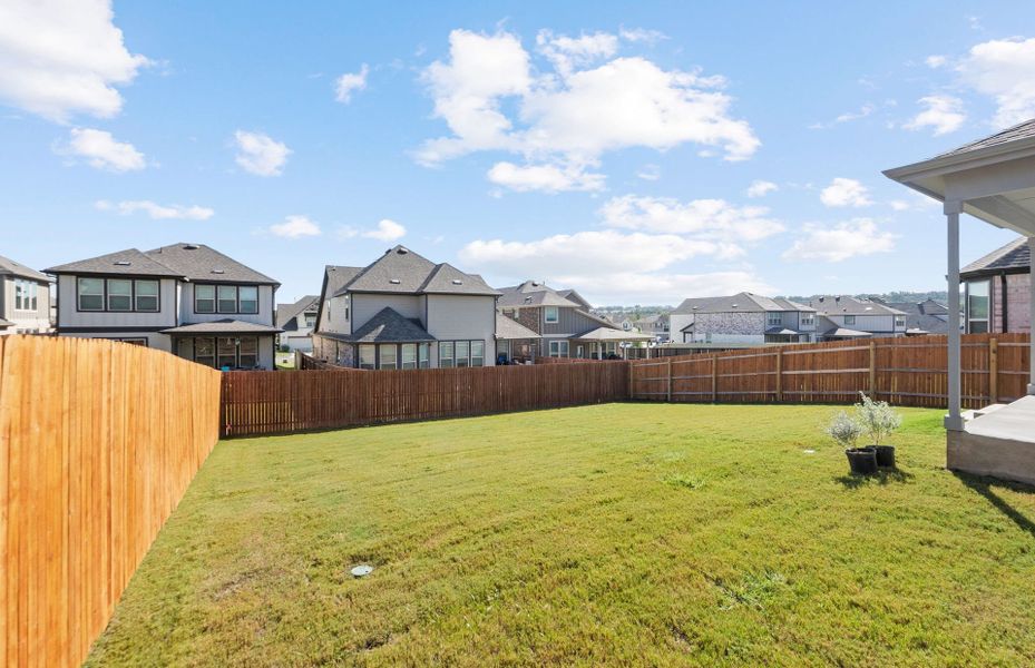 Exterior details and patio area of a home in Saddleback at Santa Rita Ranch, Liberty Hill (Image 27).