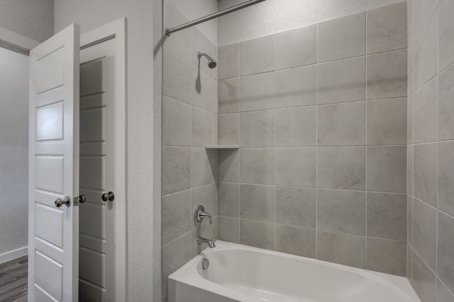 A bathroom with a bathtub and shower. A bathroom with a bathtub and shower.