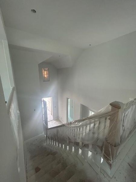 Entryway & stairway with soaring ceiling