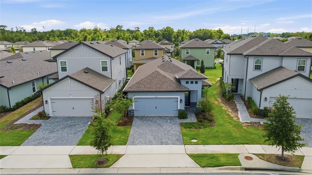 Front exterior of a new home in Reunion Village, Kissimmee, FL, highlighting curb appeal (Image 21).
