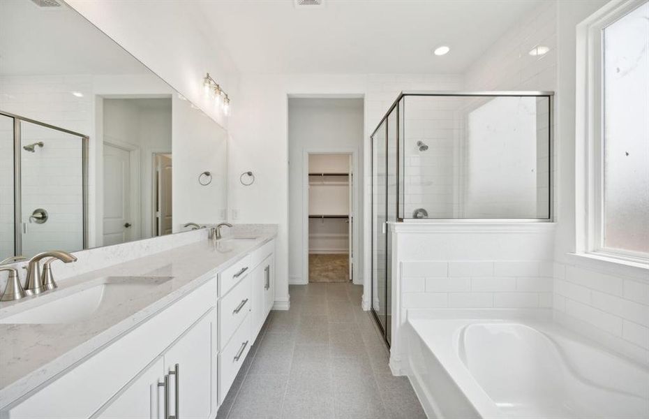 Owner's bath with dual vanity and oversized shower *real home pictured