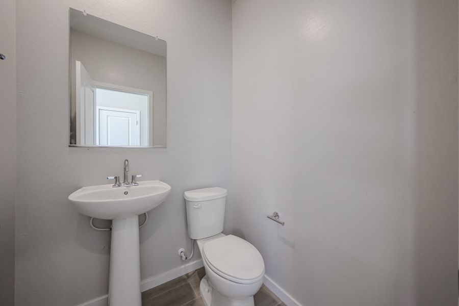 A bathroom with a sink and toilet.