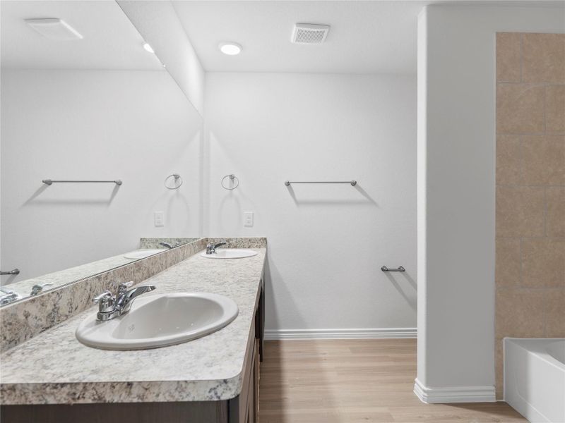 Luxurious upstairs master bath with a sleek double-sink vanity.