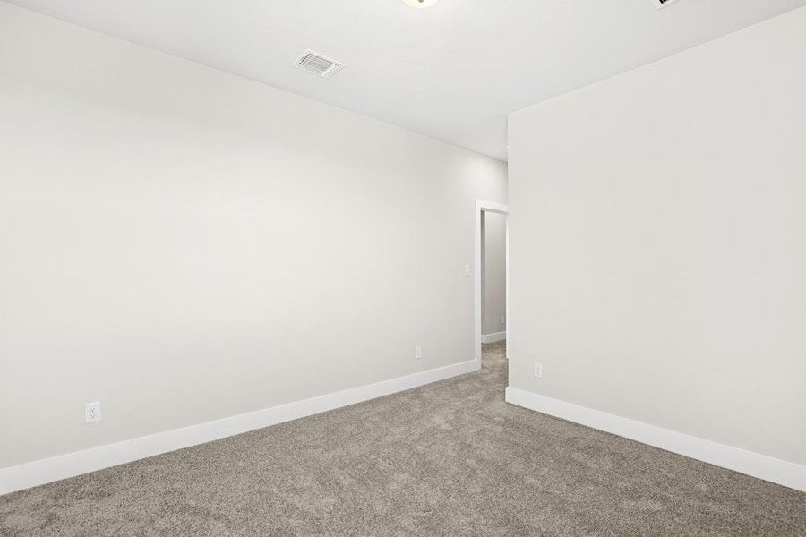 Carpeted empty room with baseboards Carpeted empty room with baseboards