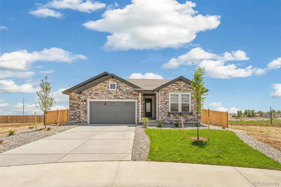 Front exterior of a new home in Windsong, Thornton, CO, highlighting curb appeal (Image 20).