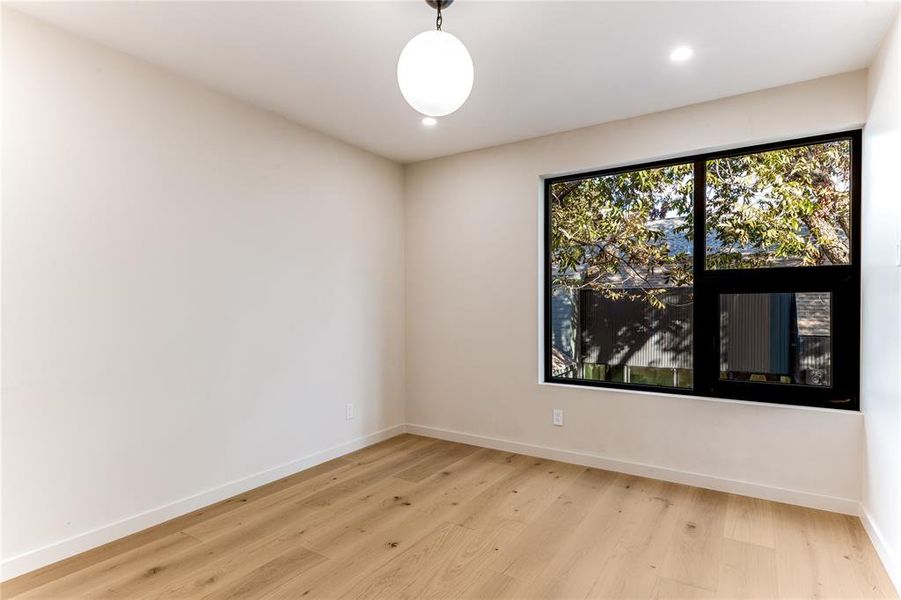 Unfurnished room with light wood-style flooring and recessed lighting