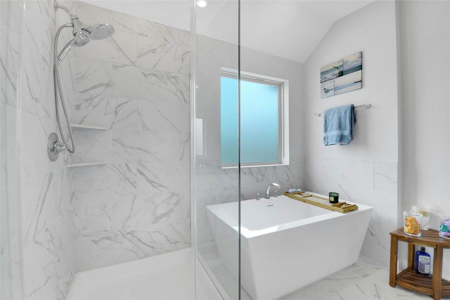 Primary bath upgrades include the frameless shower surround and the stand-alone tub.