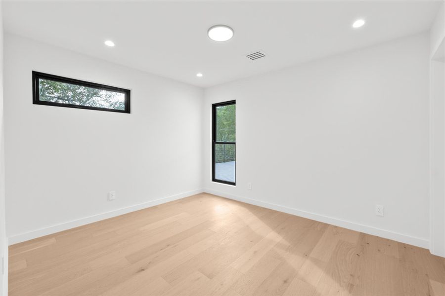 Unfurnished room with light wood-style flooring, baseboards, and recessed lighting