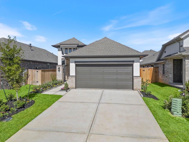 Front exterior of a new home in Grand Central Park, Conroe, TX, highlighting curb appeal (Image 20). Front exterior of a new home in Grand Central Park, Conroe, TX, highlighting curb appeal (Image 20).