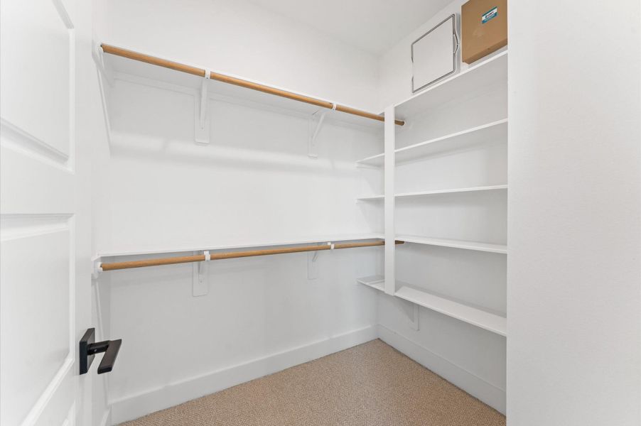 Step into the epitome of everyday luxury with this spacious walk-in closet, seamlessly connected to the primary bathroom. Step into the epitome of everyday luxury with this spacious walk-in closet, seamlessly connected to the primary bathroom.