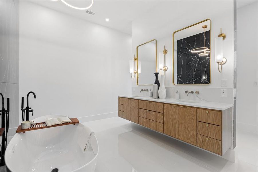 Bathroom with tile patterned flooring, vanity, and a bath